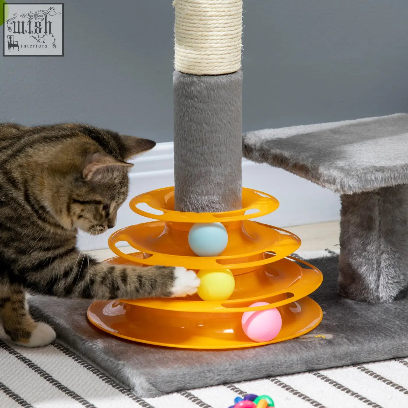 Orange plastic cat tree tower with sisal scratching posts and colorful toy balls for kitten play and climbing