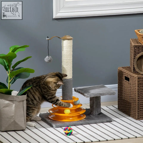 Orange plastic cat toy with rotating tiers and colorful balls on grey pawhut cat tree with sisal scratching posts