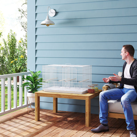 White metal pawhut bird cage with 2cm bar spacing, 4 wooden perches, slide out tray, and 4 food dishes on wood table