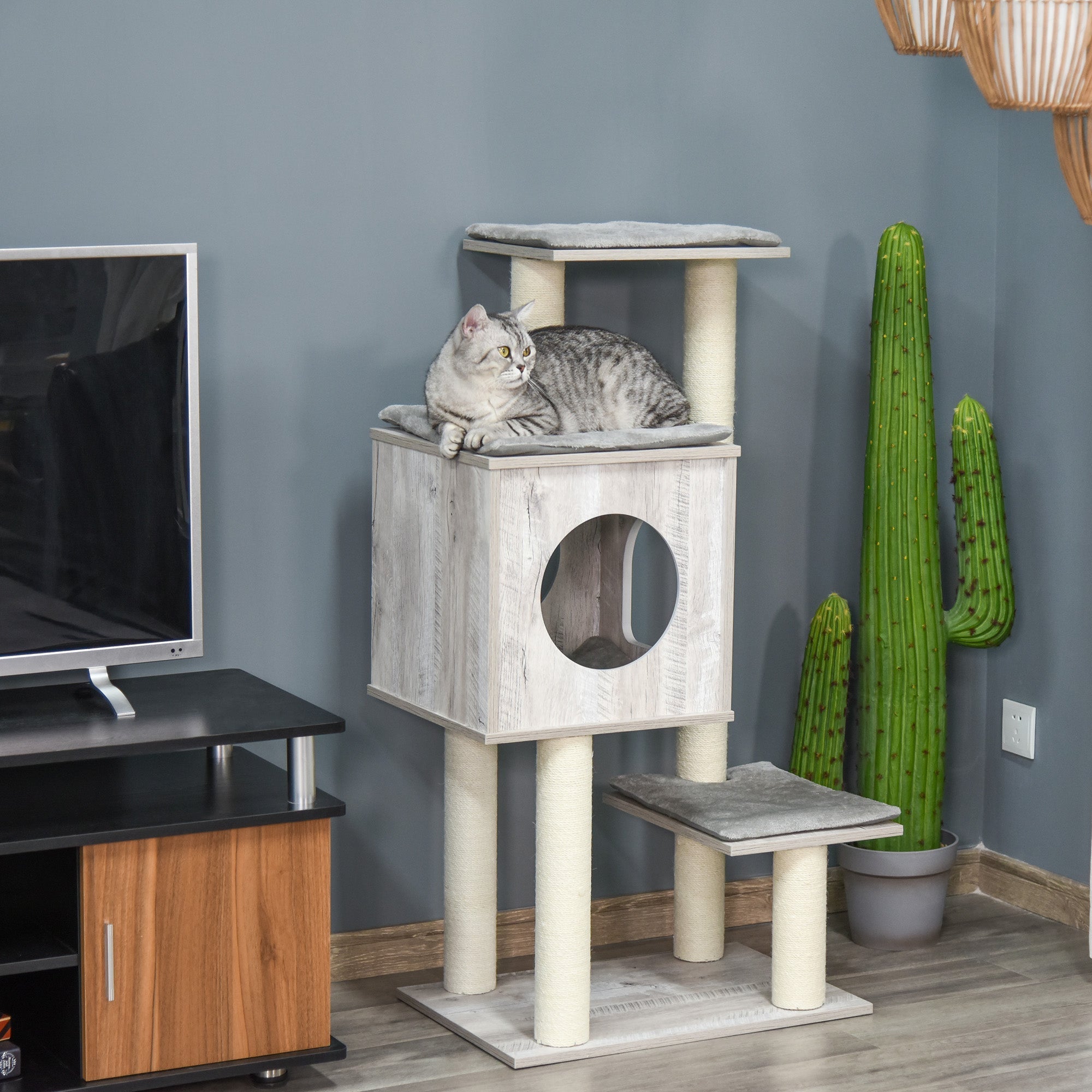 Gray tabby cat lounging on a light gray cream pawhut cat tree with jute scratching post 60l x 40wcm for large cats