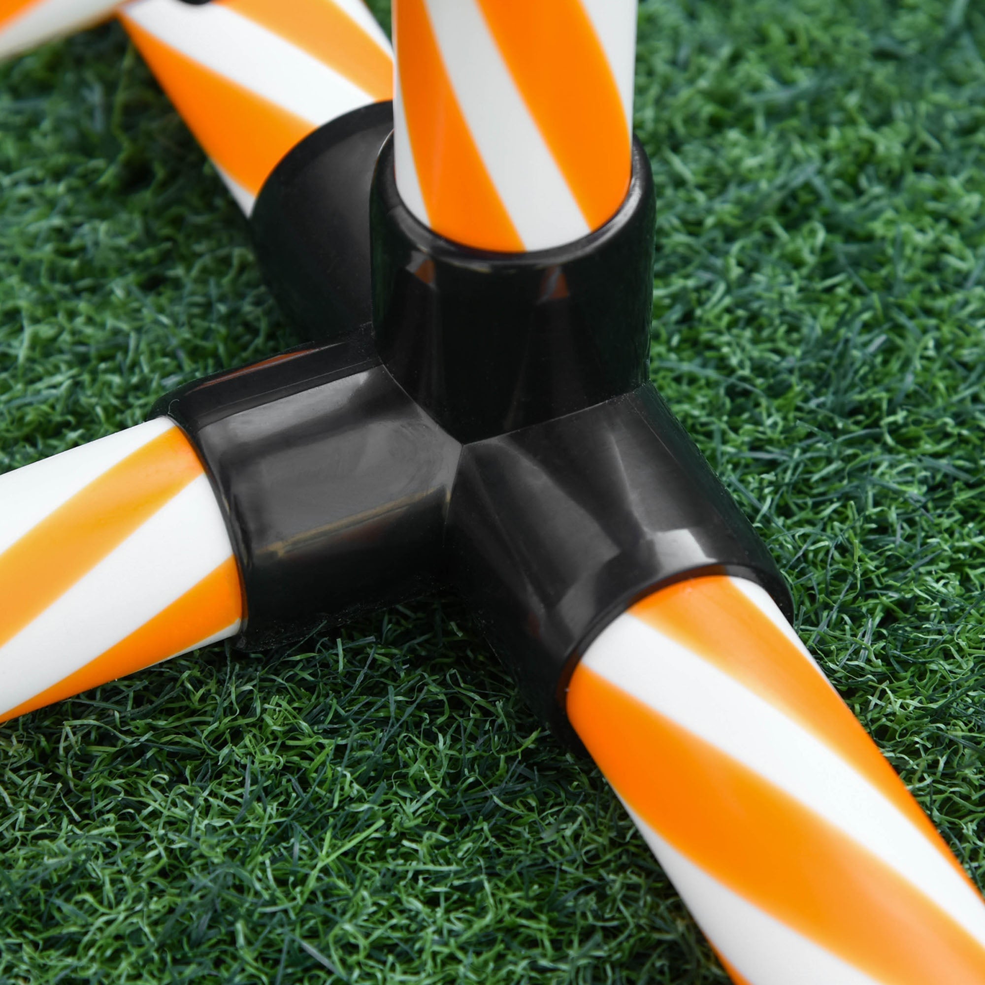 Orange and white striped plastic weave poles connected by black joints for pawhut dog agility training outdoors