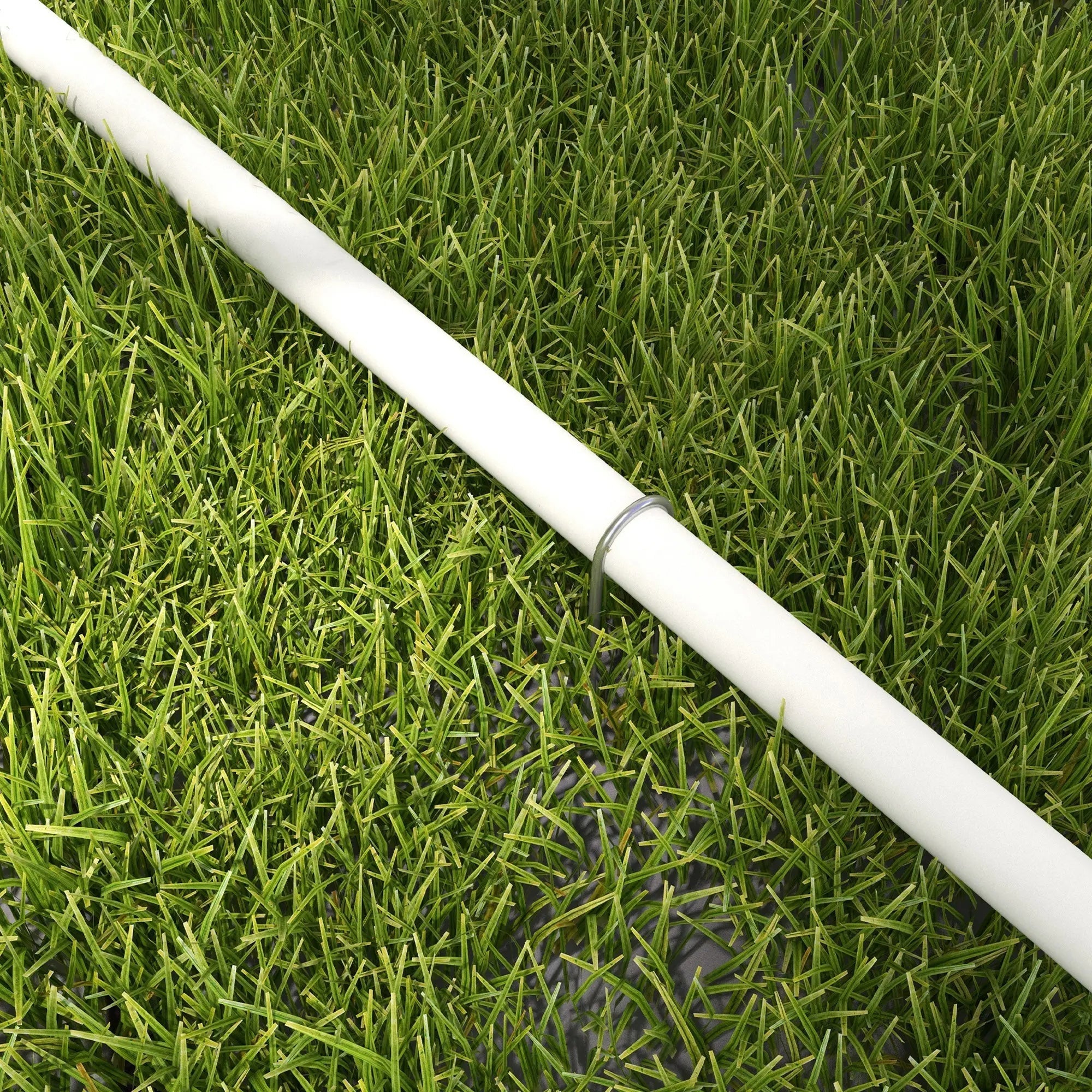 White plastic pipe from pawhut dog agility equipment set lying on green grass with oxford carry bag in background