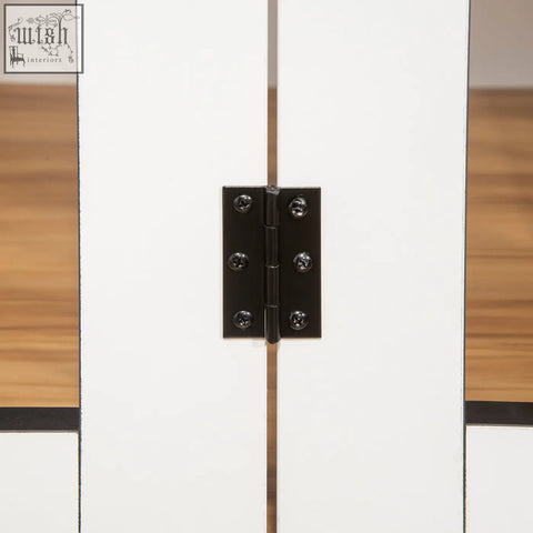 Close-up of black metal door hinge with screws on the lockable door of white pawhut dog crate furniture for medium dogs