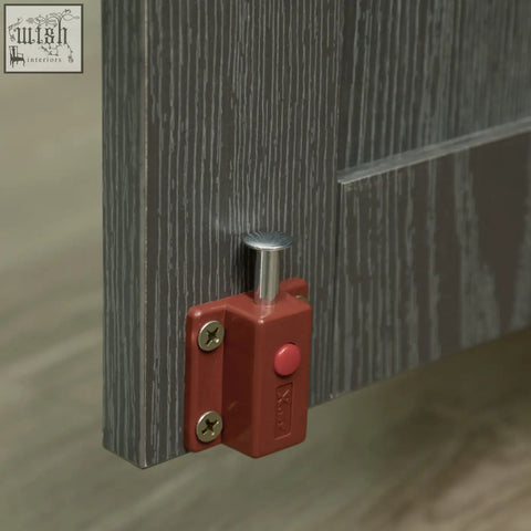 Red plastic door stop with silver metal lever and screws on pawhut dog crate table with magnetic door grey