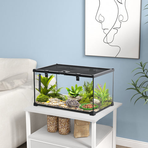 Pawhut black-framed glass reptile box with strip patch thermometer housing a tortoise and green plants on pebbles