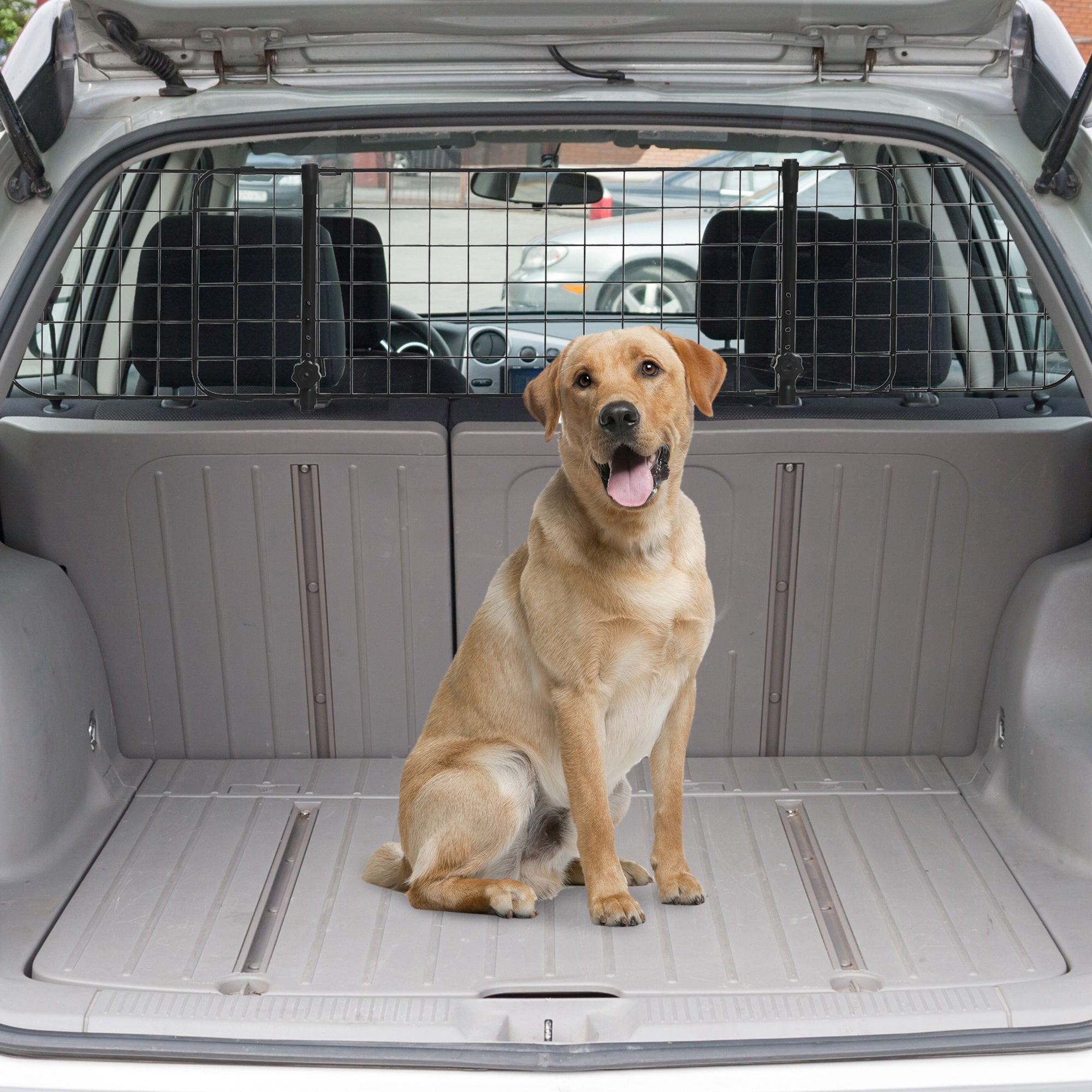A tan labrador sits in the open trunk of a car behind a black pawhut heavy duty pet barrier for safe car pet travel