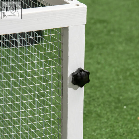White wooden frame rabbit hutch with steel wire mesh and lockable doors featuring a black star-shaped knob