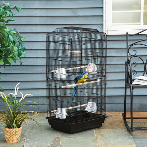 Black metal bird cage with wooden perches, two large food bowls, and a blue yellow parrot inside by PawHut