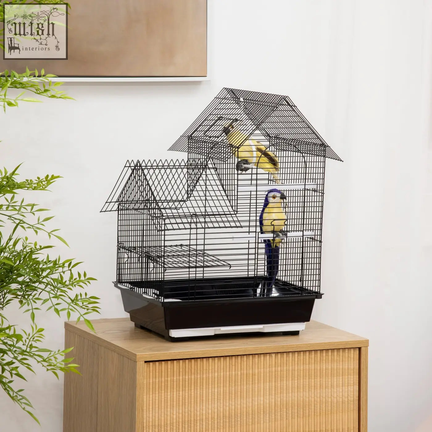 Black metal bird cage with house-shaped roof, two yellow birds, swing ring, and food containers by PawHut