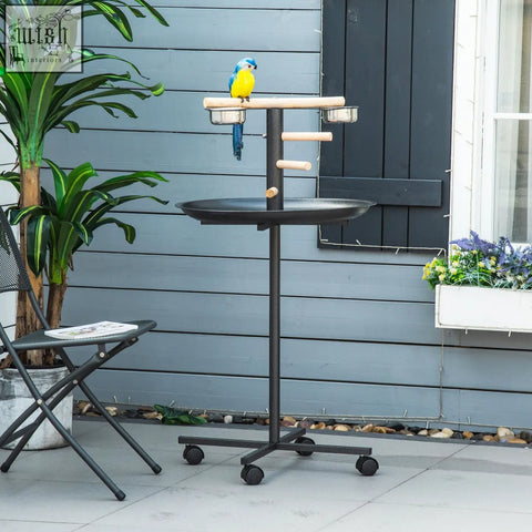 Black metal bird stand with wooden perches and two stainless steel bowls on round tray by pawhut