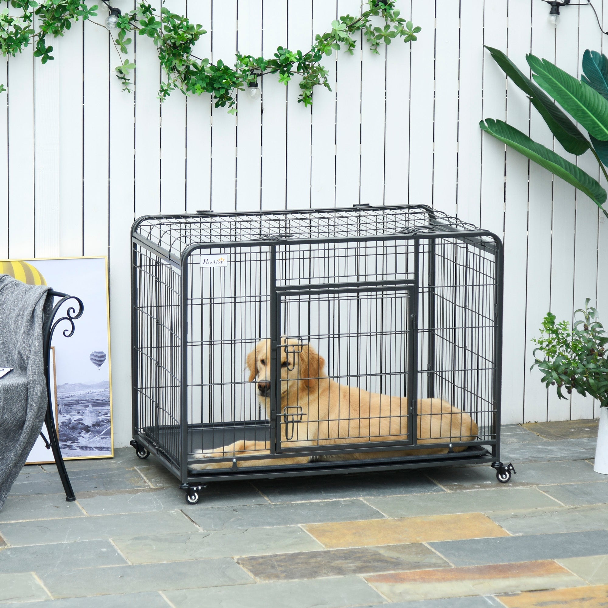 Black metal wire dog crate with four locking wheels, easy access sliding door, and removable tray for large pets