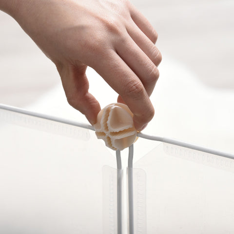 Beige glossy spherical cable organizer with faceted diy design, perfect for small animals like guinea pig setups
