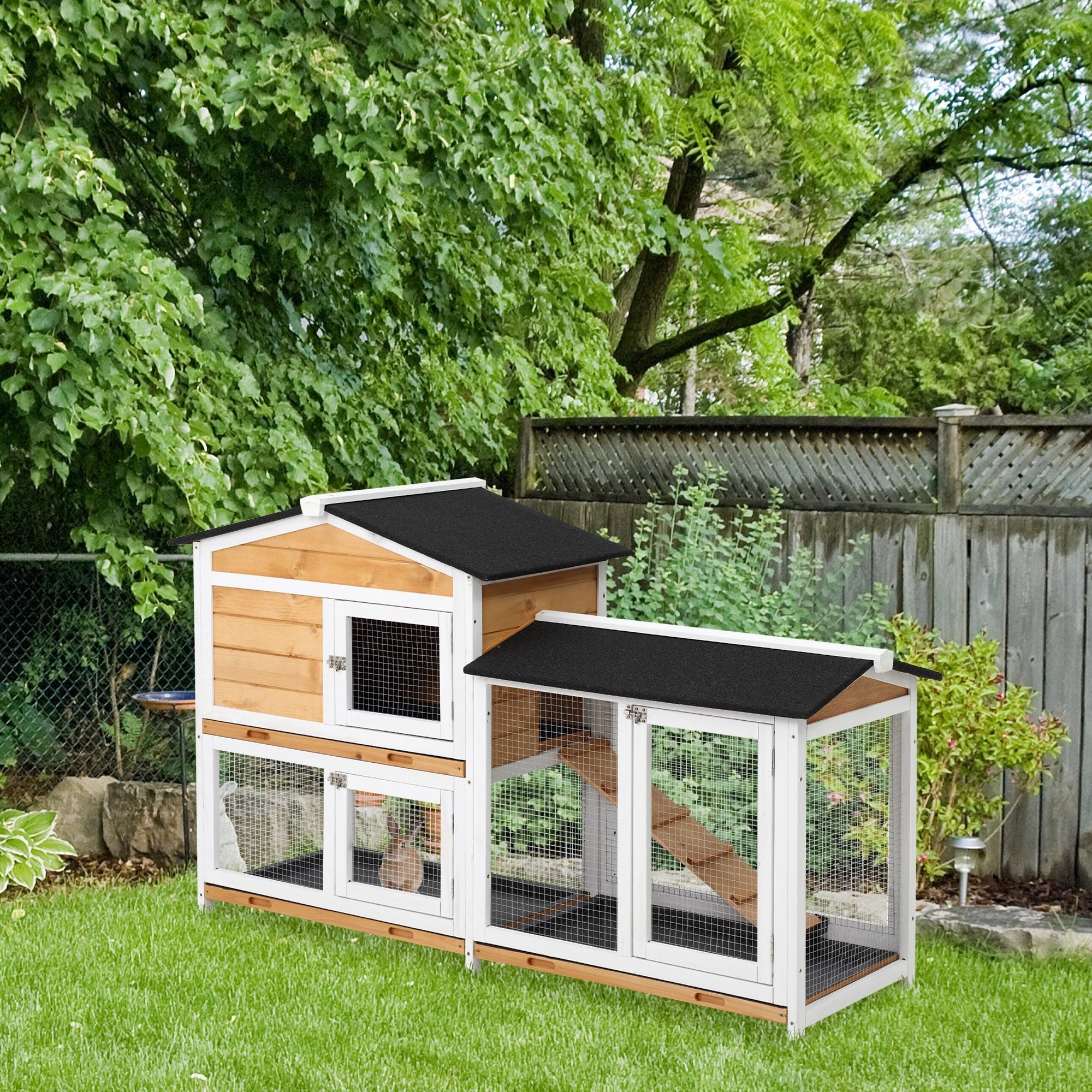 Two tier wooden rabbit hutch with white trim black roof panels and run box for outdoor living house use