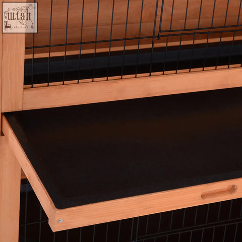 A pawhut fir wood rabbit hutch with an asphalt roof and black rubber mat designed for two pets in orange color