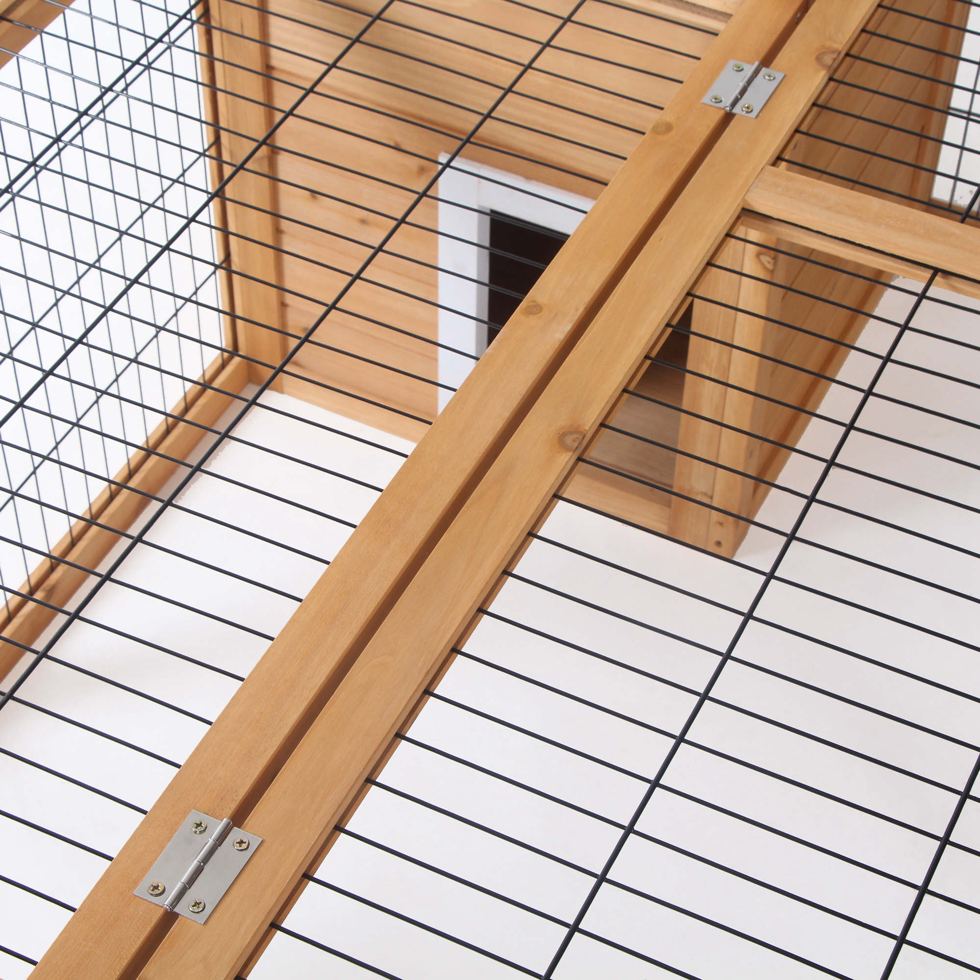 Light-colored wooden frame with black wire mesh panels and metal hinges on pawhut rabbit hutch main house top