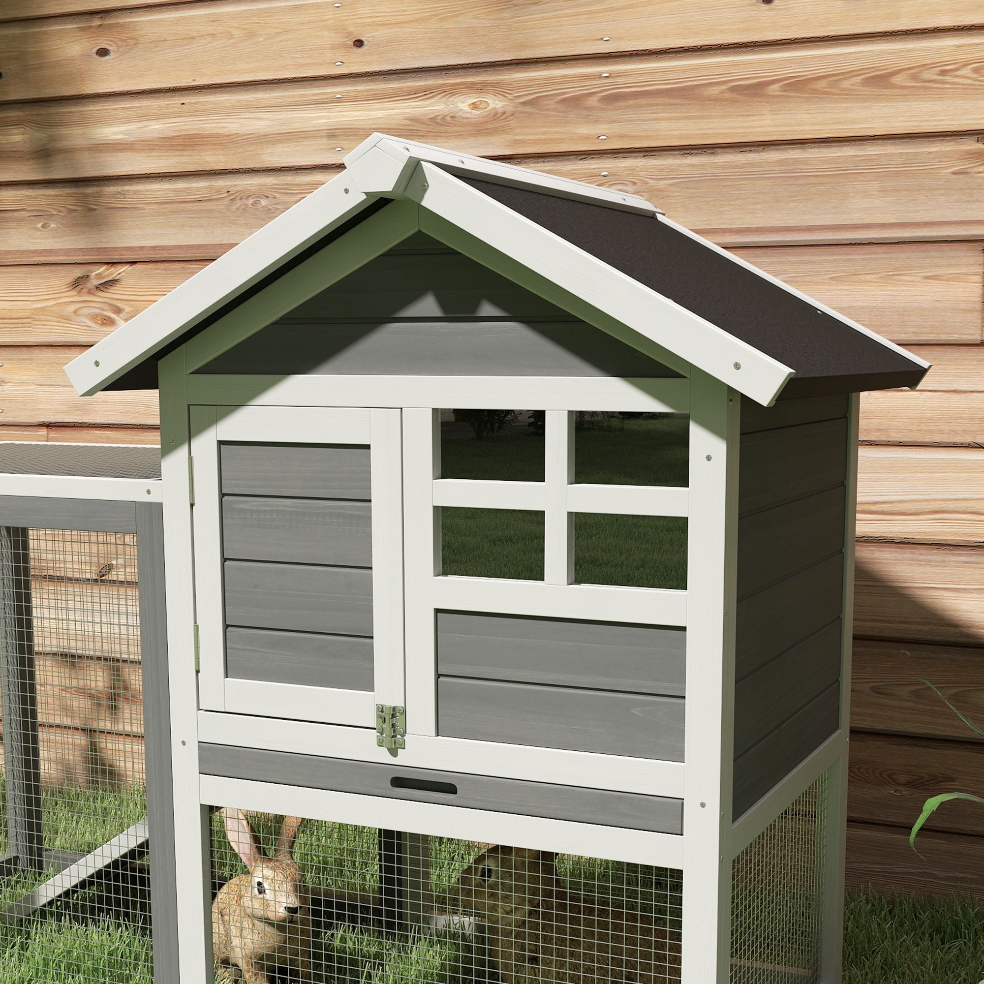 A pawhut rabbit hutch made of fir wood with a white roof gray siding windowed door and wire mesh sides for outdoor use
