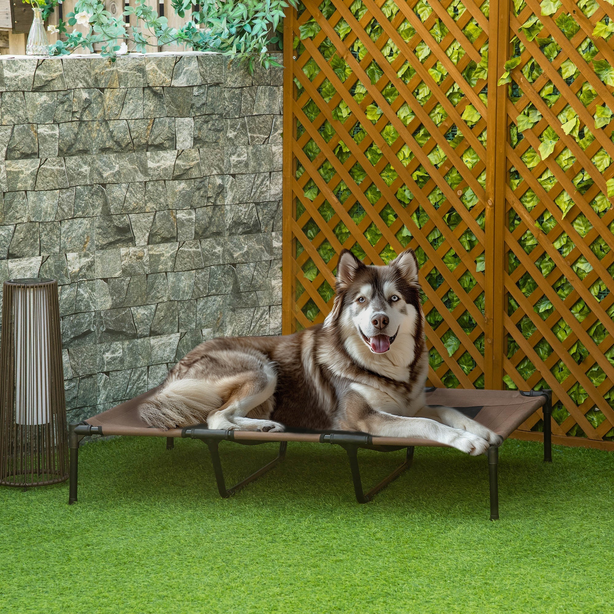 Brown fabric dog bed with black metal frame lets air flow for indoor outdoor use by PawHut elevated pet cot xl
