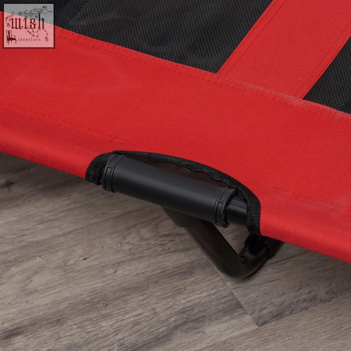 Red and black fabric elevated dog bed with sturdy plastic handle lets air flow for indoor outdoor use
