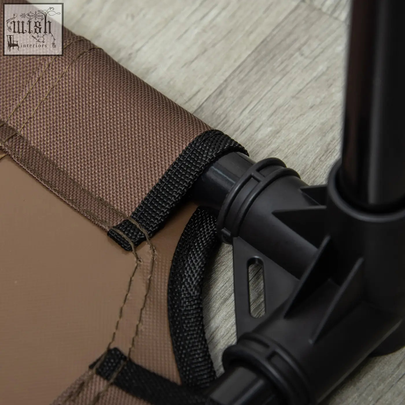 Brown fabric with black webbing straps and plastic connector on pawhut elevated dog bed for large dogs