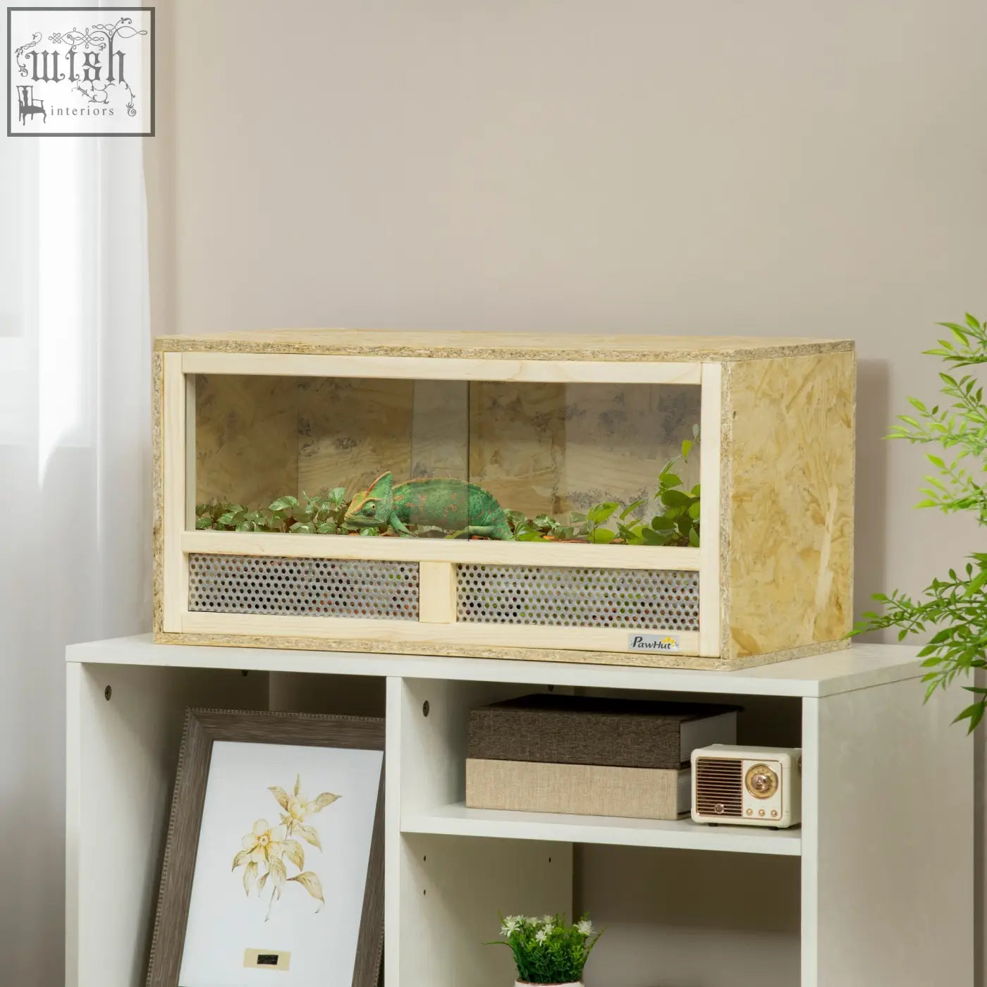 A light wood-finished pawhut reptile terrarium with breathable mesh panels and sliding doors housing a green chameleon