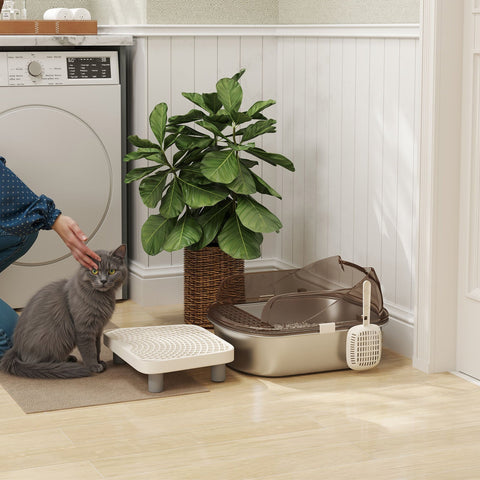 Gray cat sits next to a beige pawhut stainless steel litter box with lid scoop and high wall sided enclosure