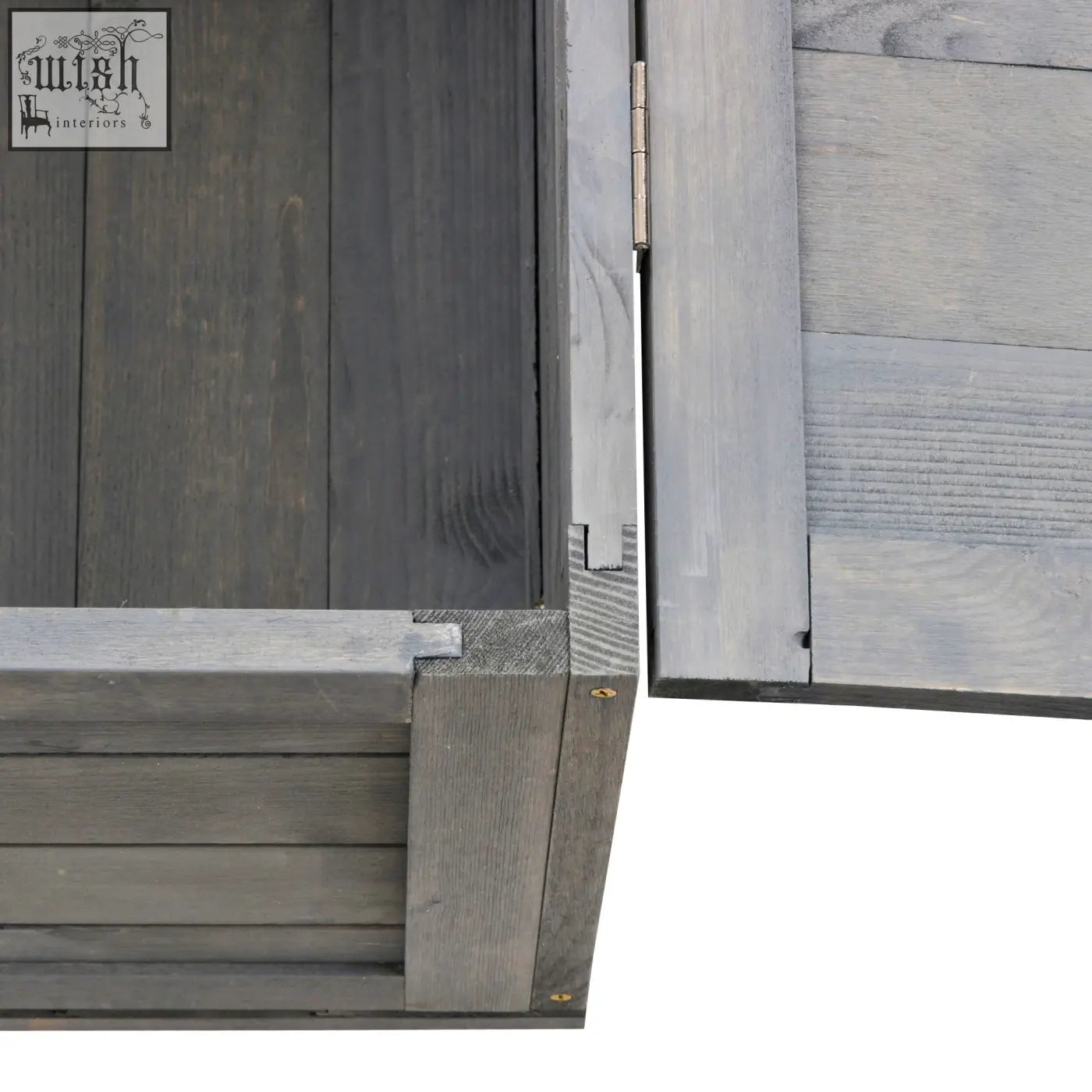 Dark gray wooden door with metallic hinge on pawhut tortoise house with light gray wood paneling side panels