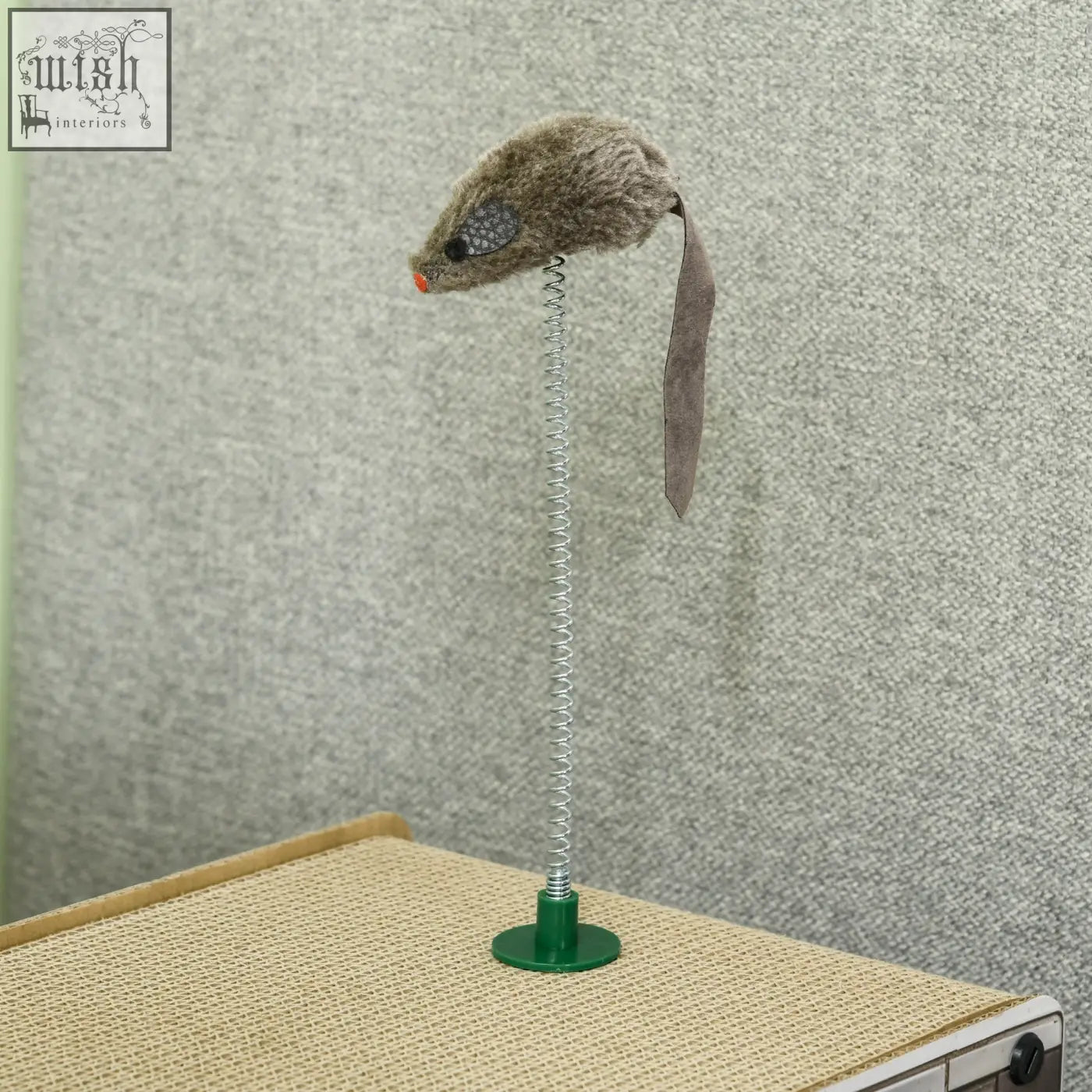 Furry gray mouse toy with orange nose on silver spring attached to green base of pawhut corrugated cardboard scratching board for cat scratching