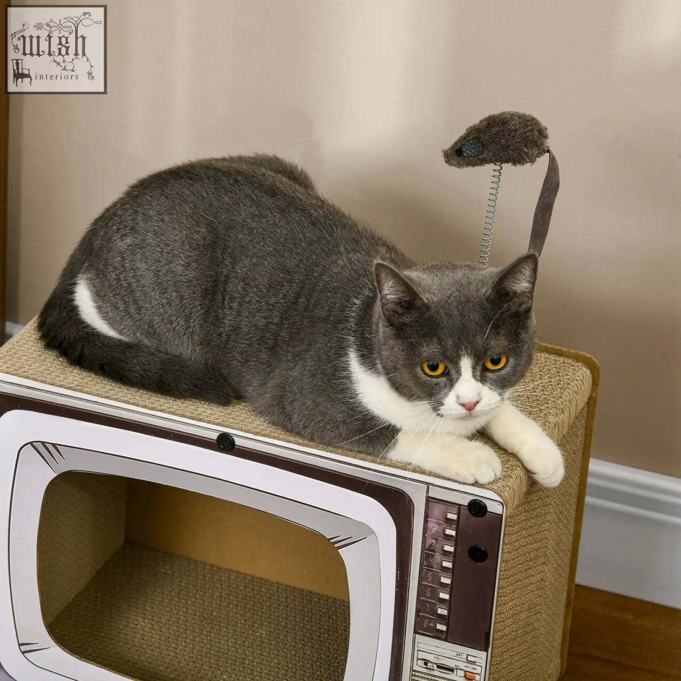 Gray and white cat lounging on pawhut gray retro tv-shaped corrugated cardboard scratching board with mouse toy for cat scratching
