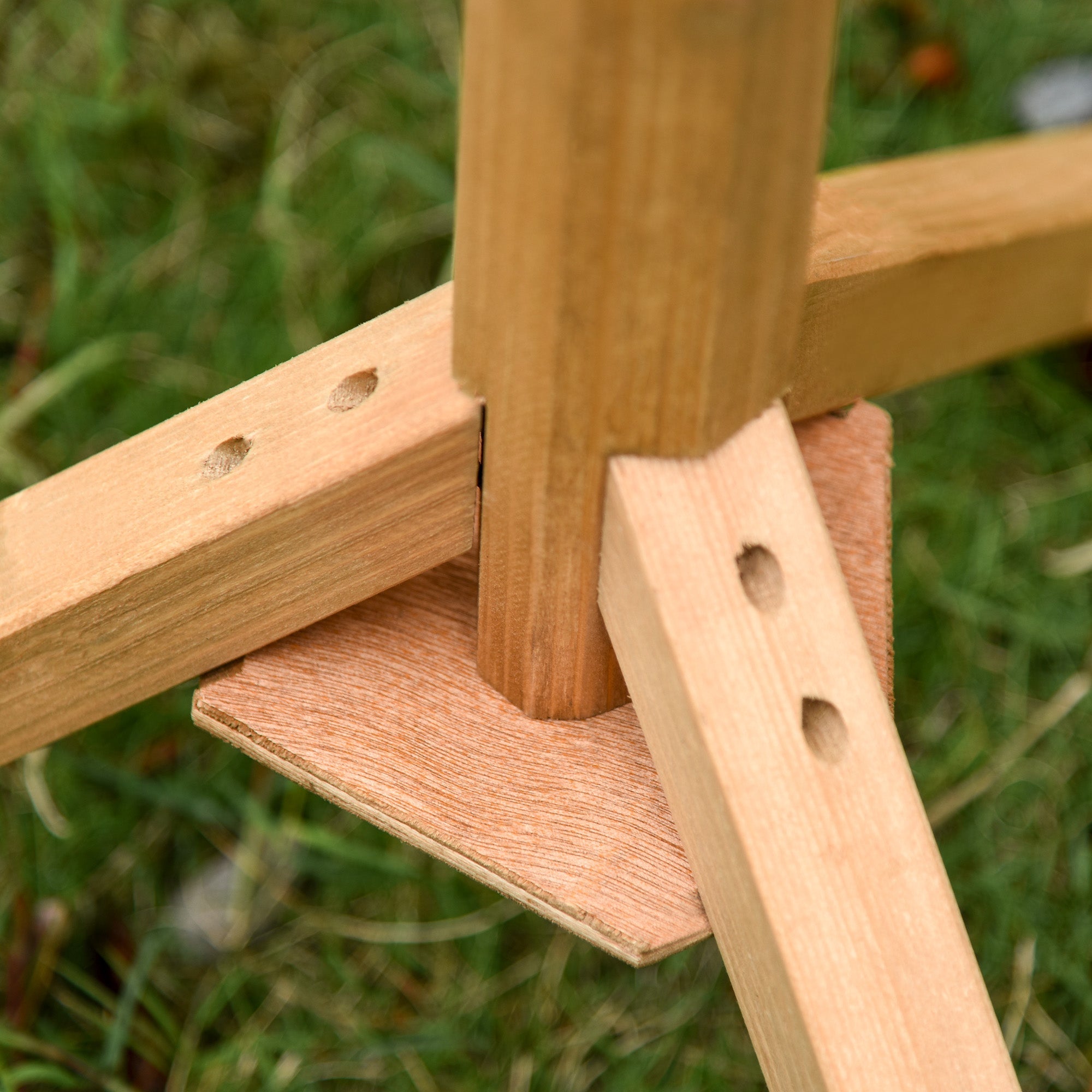 Light brown solid fir wood easel leg with visible grain and three holes on the back of pawhut wooden bird table