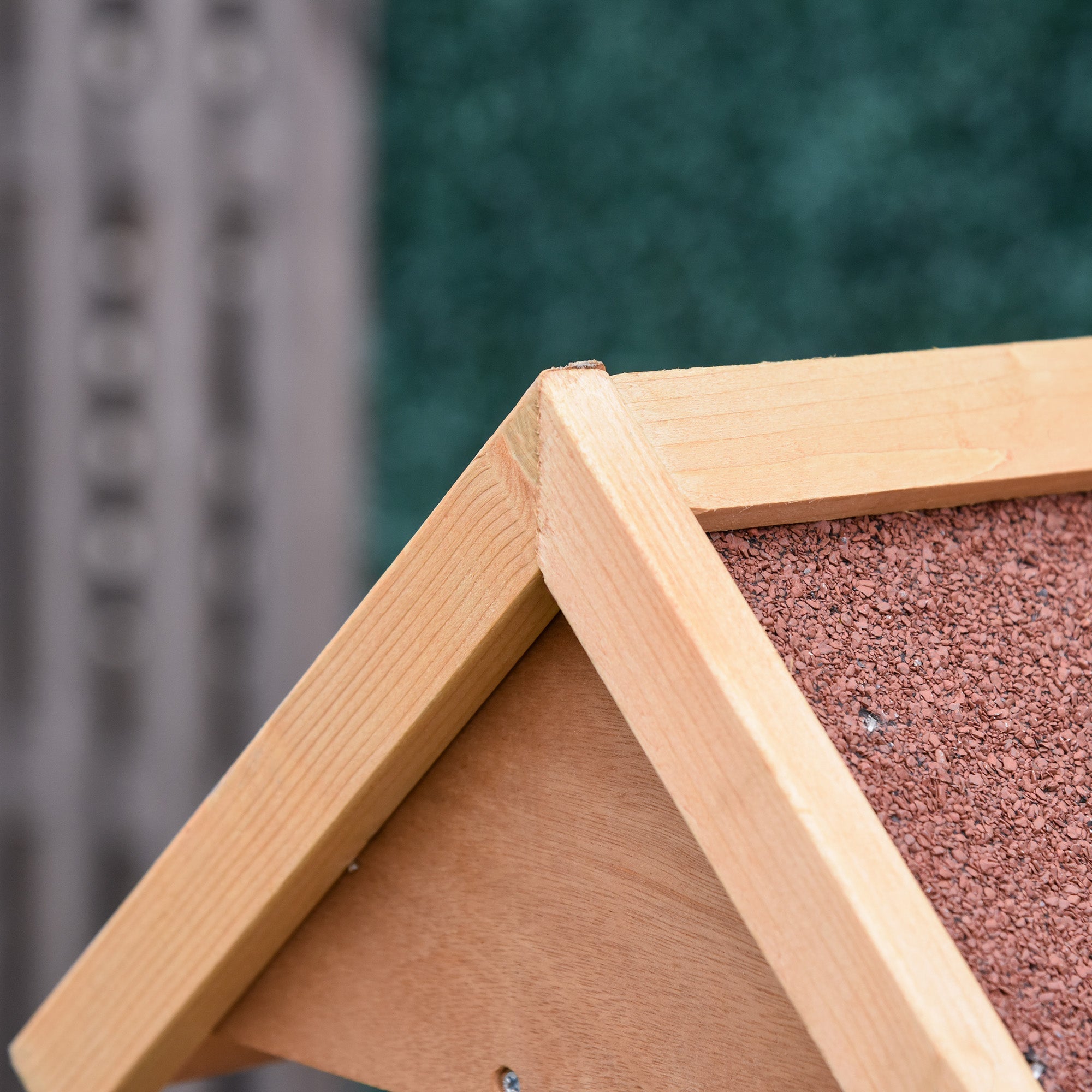 Light-colored fir wood bird feeder with slanted roof and reddish-brown corkboard interior for outdoor garden use