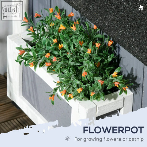 Grey pawhut wooden cat house with white wooden flower box filled with green foliage and orange flowers outdoors