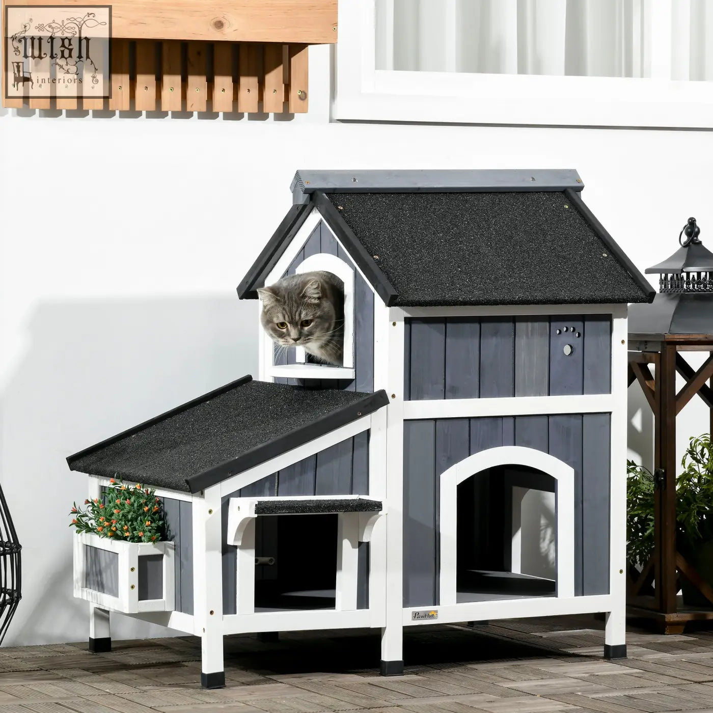 Gray and white pawhut wooden cat house with flower box featuring arched doorways and tabby cat on window perch