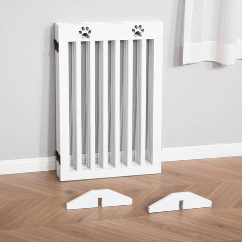 White wooden pet gate with paw print cutouts and foldable freestanding design with matching support feet