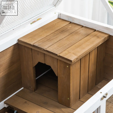 Rustic brown wooden rabbit hutch by pawhut with slanted roof, wire mesh window, tray, ramp, and wheels for easy use