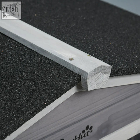 Light gray solid fir wood trim with a weathered finish on the edge of a pawhut guinea pig cage roof