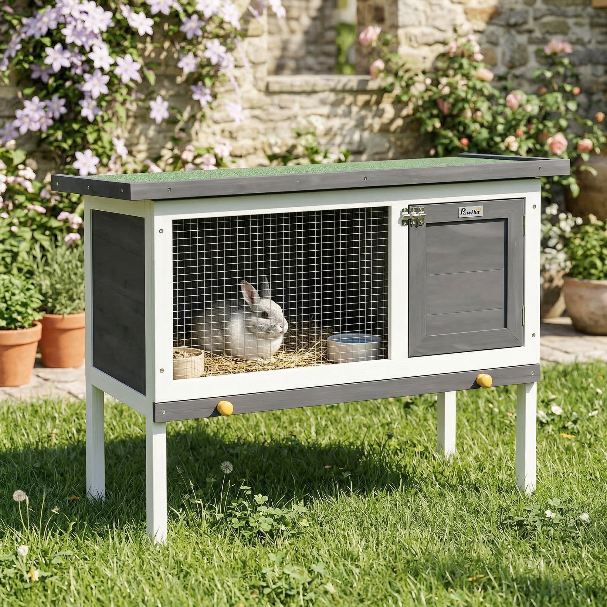 Gray and white wooden pawhut rabbit hutch with asphalt roof green top wire mesh front and yellow leg knobs for guinea pig use