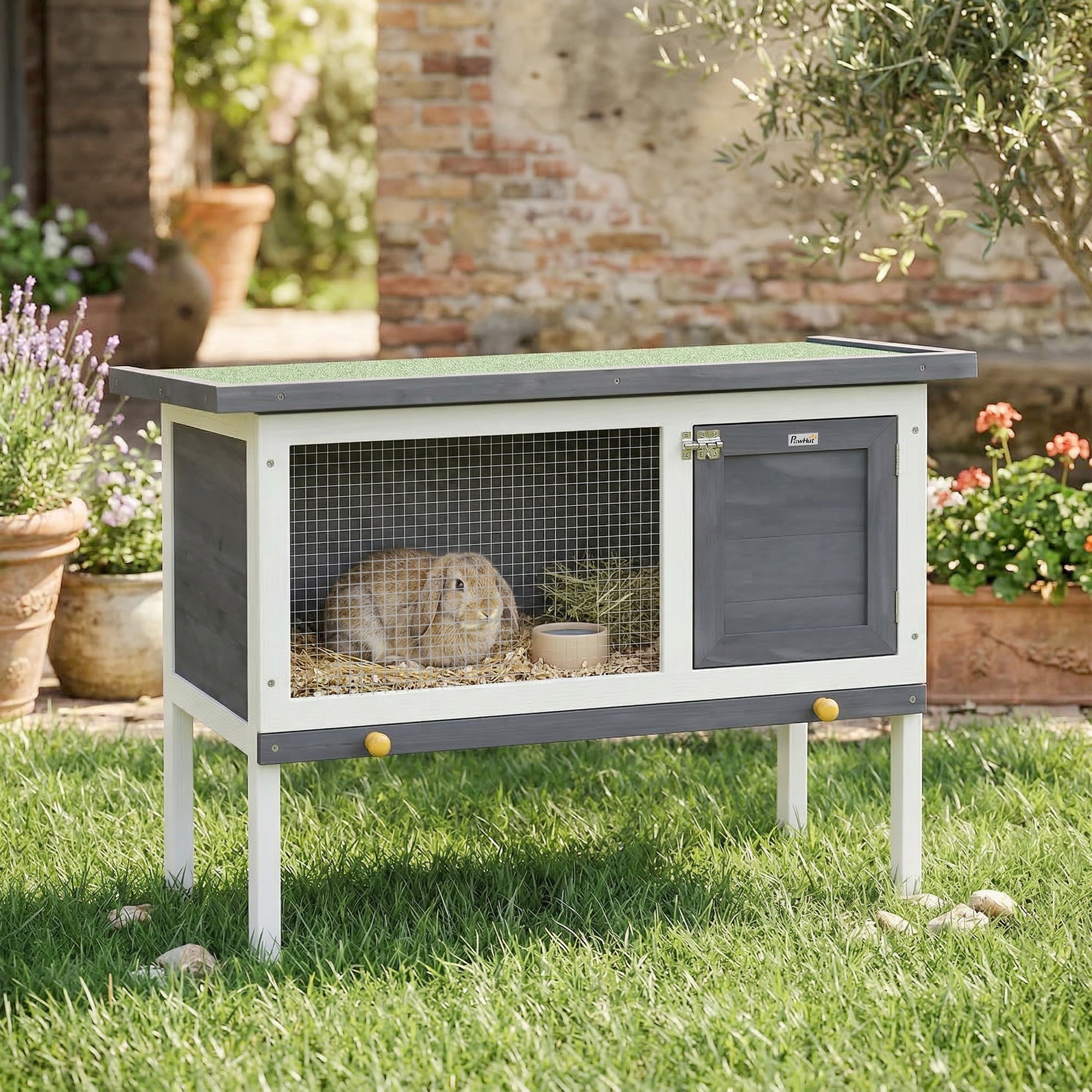 Gray and white wooden pawhut rabbit hutch with green asphalt roof, wire mesh front, yellow knobs, water-resistant paint