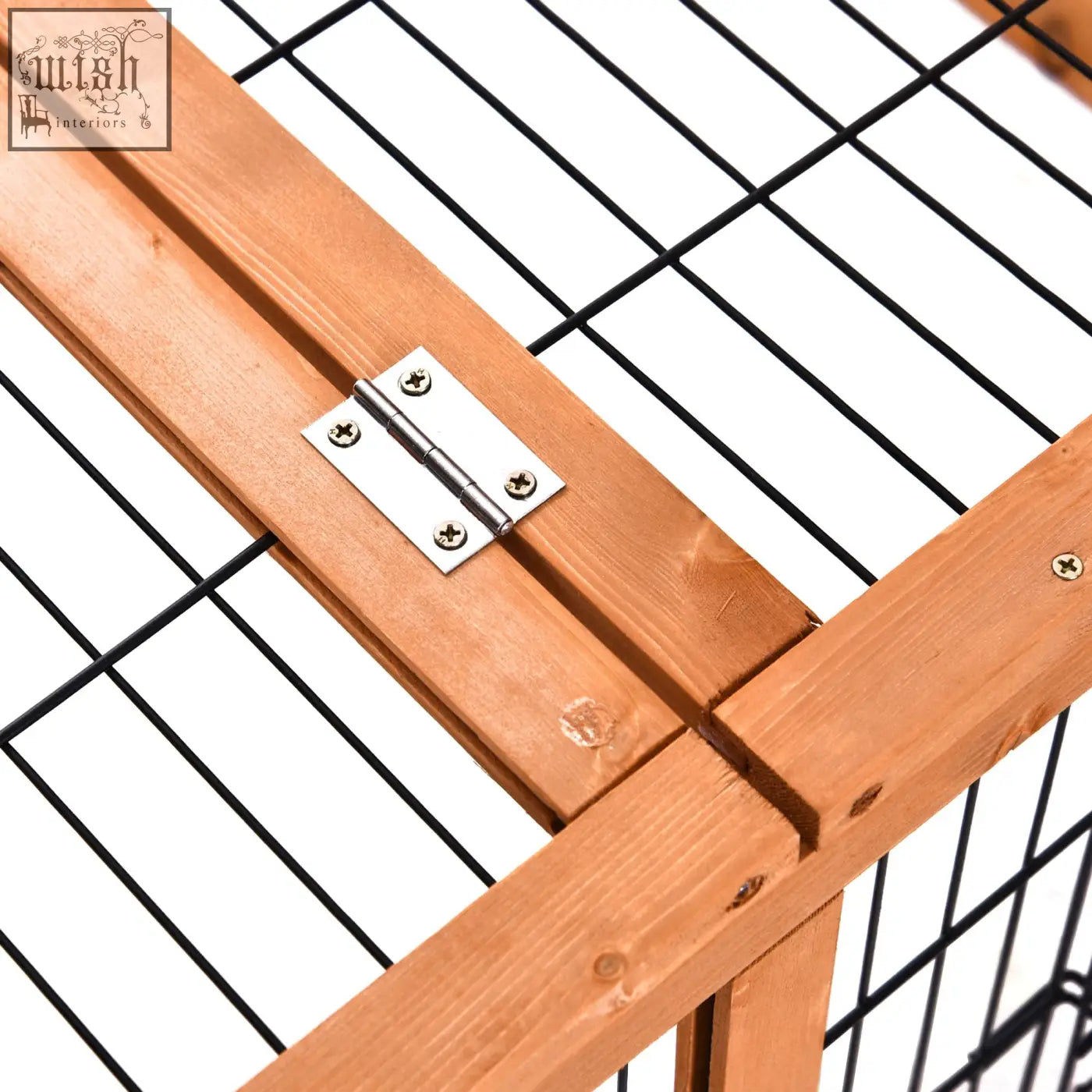 A silver metal hinge attached to light brown wooden beams on the enclosed main house of a pawhut wooden rabbit hutch