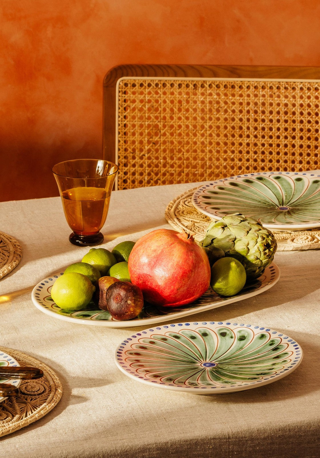 A ceramic peacock side plate with green and white radial patterned design perfect for serving appetizers
