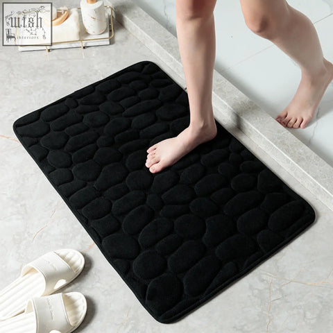 Black pebble textured floor mat with plush memory foam and non slip surface for bathroom water absorption