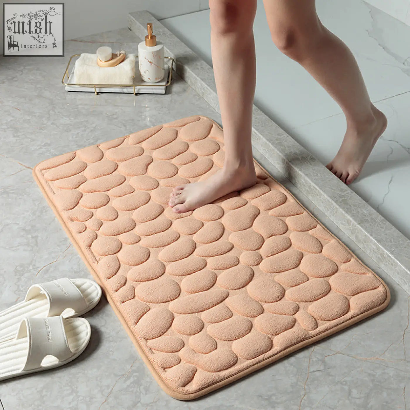 Beige pebble textured floor mat with soft memory foam and plush material for bathroom water absorption use