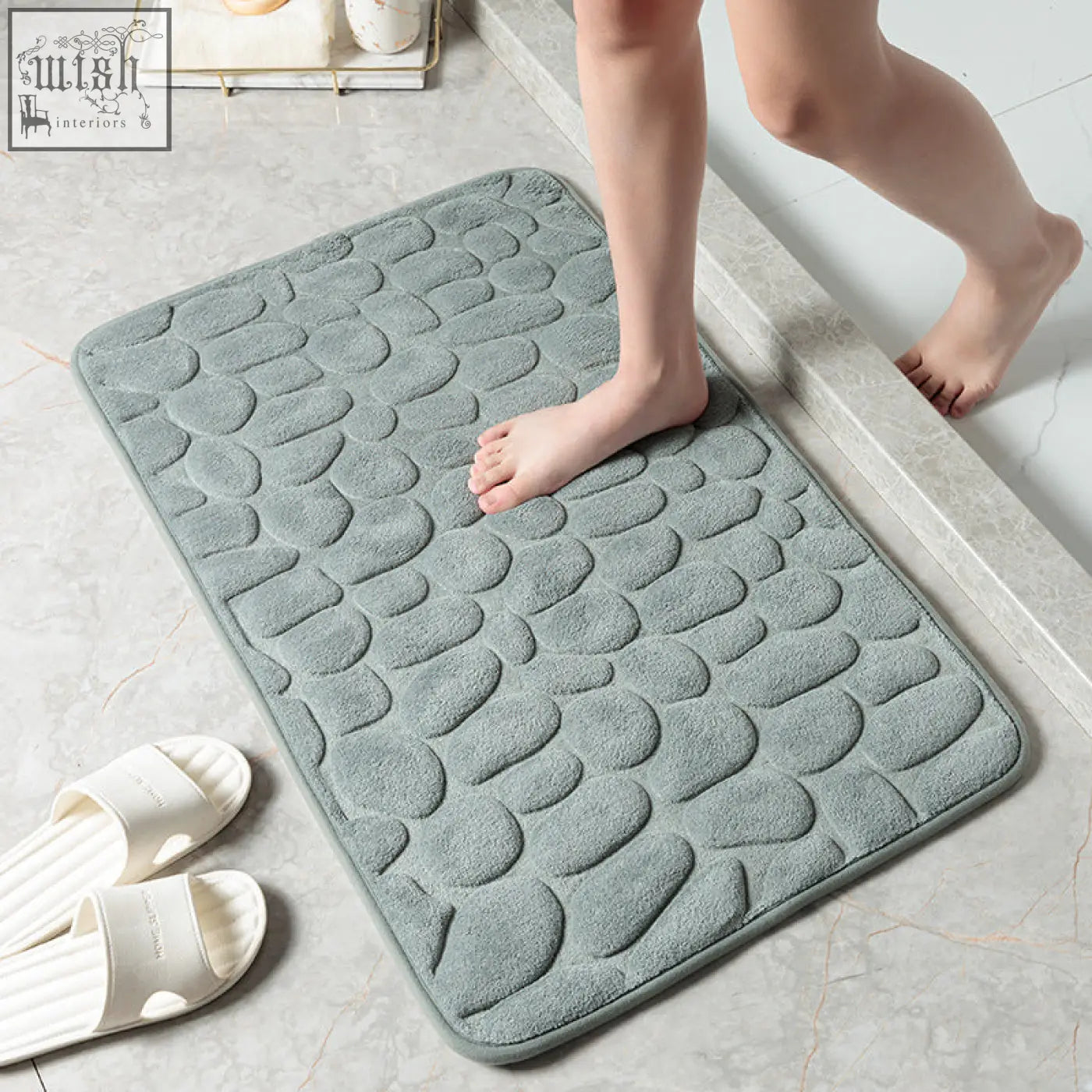 A soft slate-gray pebble stone bathroom floor mat with plush memory foam and excellent water absorption