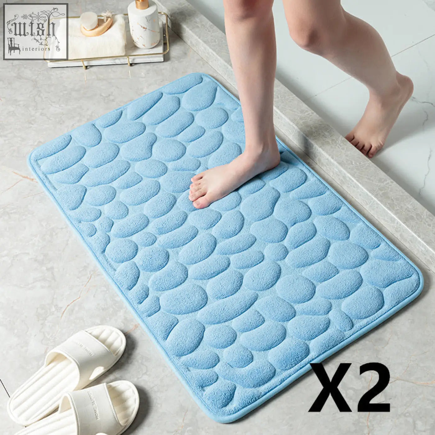 Light blue pebble stone bathroom floor mat with soft plush memory foam and textured surface for water absorption