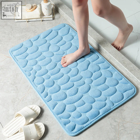 Light blue plush memory foam bathroom floor mat with textured pebble pattern for water absorption and comfort