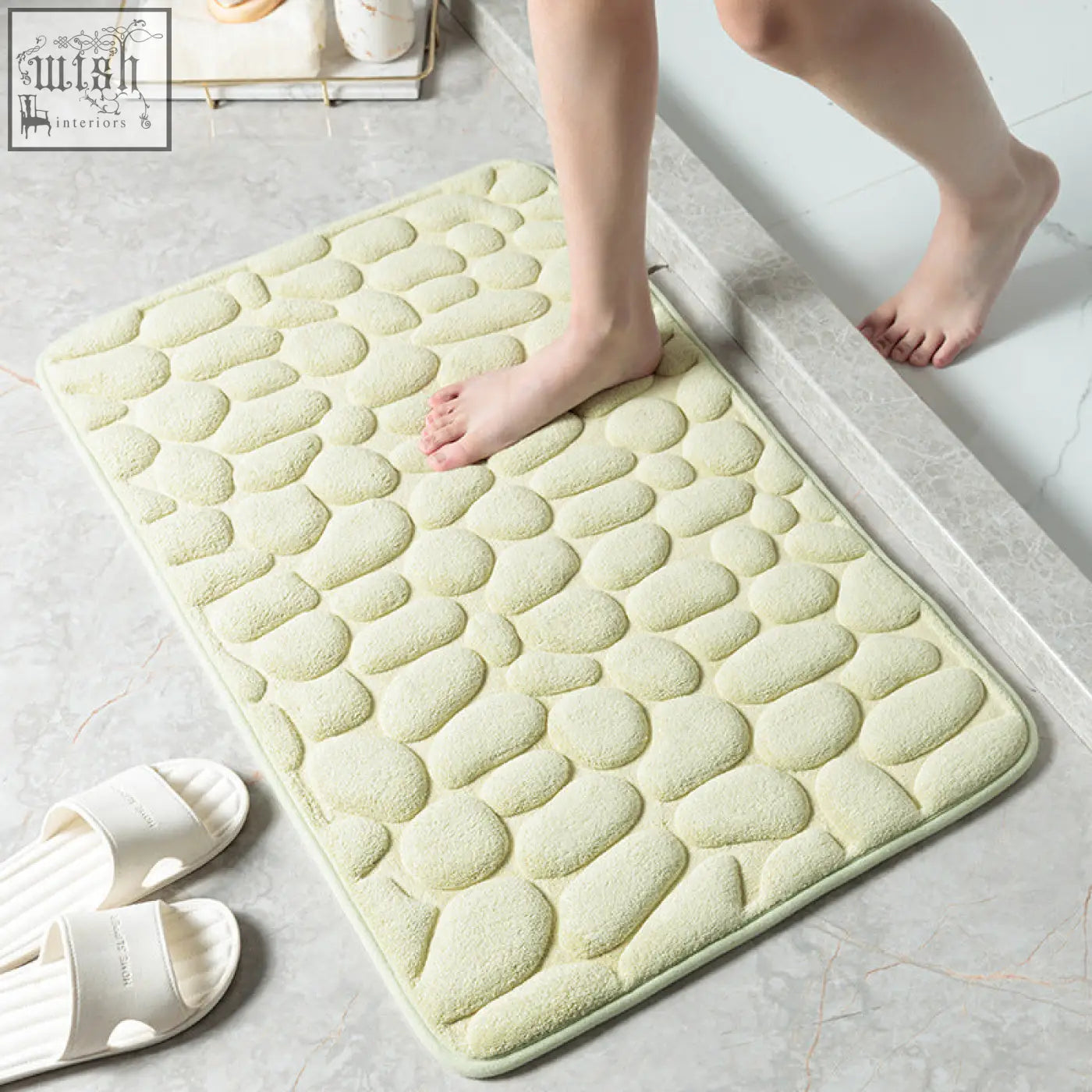 A soft pale green pebble stone bathroom floor mat with memory foam texture for water absorption and comfort