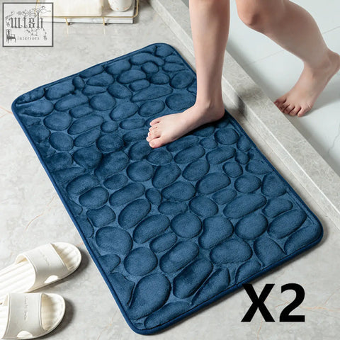 Deep blue pebble stone bathroom floor mat with plush memory foam and textured surface for water absorption