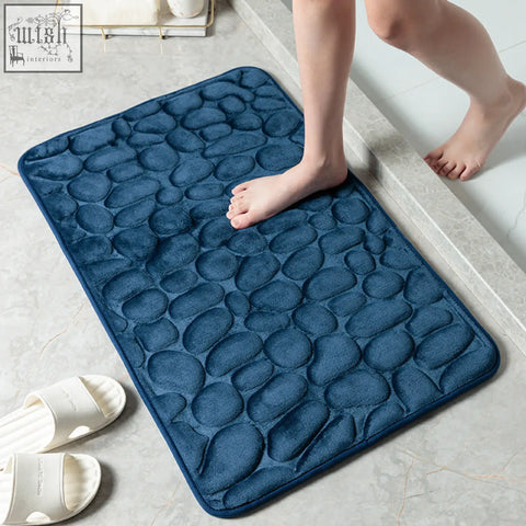 Deep blue pebble textured floor mat with plush memory foam material for bathroom water absorption and comfort