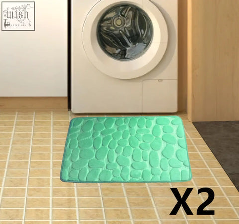 Mint green pebble textured floor mat with memory foam for water absorption perfect as a bathroom carpet or door mat