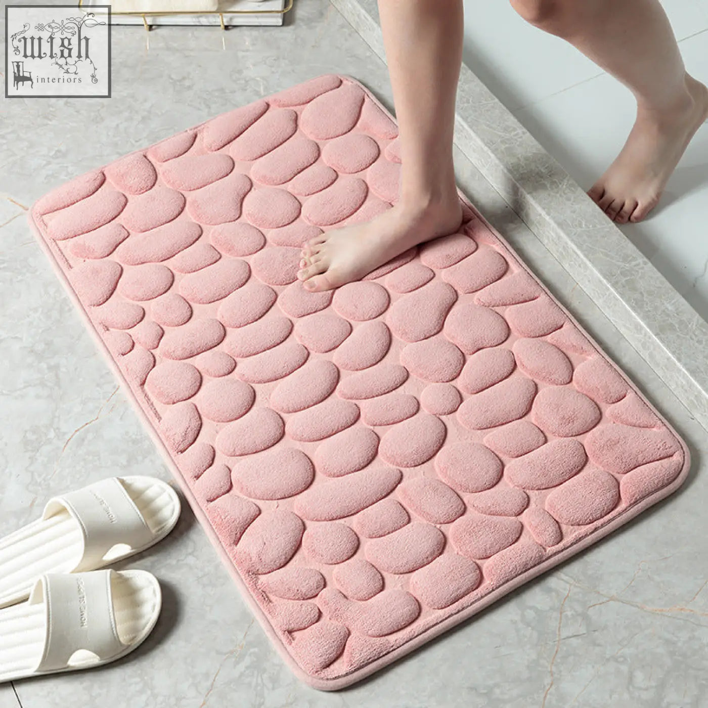 Pink pebble textured bath floor mat with soft plush memory foam material for water absorption and bathroom use