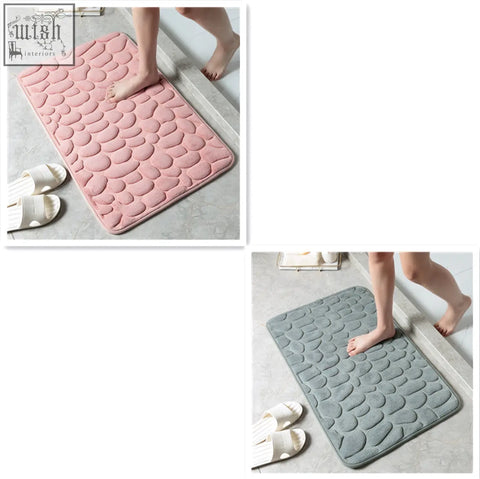 Pink and gray pebble textured floor mat with memory foam for water absorption perfect as a bathroom and door mat